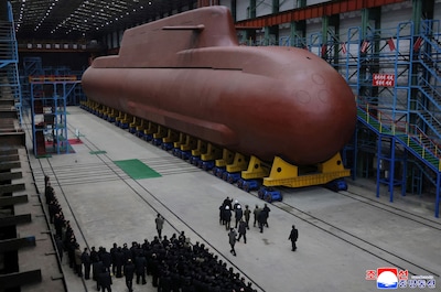 this-undated-picture-released-by-north-korea-s-official-korean-central-news-agency-kcna-via-kns-on-december-25-2025-shows-north-korean-leader-kim-jong-un-visiting-the-manufacturing-site-of-an-8-700-tonnage-nuclear-powered-strategic-guided-missile-submarine-at-an-undisclosed-location-in-north-korea-photo-by-kcna-via-kns-afp-south-korea-out-editors-note-restricted-to-editorial-use-mandatory-credit-afp-photo-kcna-via-kns-no-marketing-no-advertising-campaigns-distributed-as-a-service-to-clients-this-picture-was-made-available-by-a-third-party-afp-can-not-independently-verify-the-authenticity-location-date-and-content-of-this-image