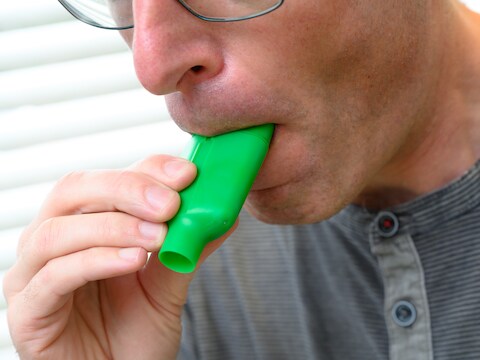 Zo ziet de ademtest eruit: iemand ademt een aantal keren uit in dit plastic flesje. 