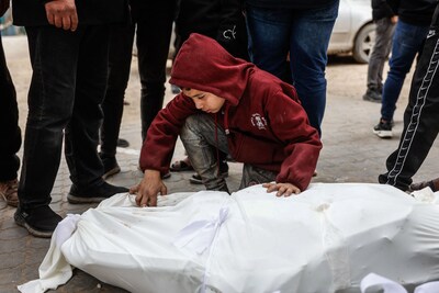 a-young-boy-mourns-over-a-body-bag-at-al-shifa-hospital-after-four-palestinians-were-killed-whilst-collecting-firewood-east-of-the-zeitoun-neighborhood-gaza-city-on-january-22-2026-the-health-ministry-in-hamas-run-gaza-said-on-january-22-that-the-overall-death-toll-since-the-war-broke-out-on-october-7-2023-now-stands-at-71-562-since-october-10-a-fragile-truce-in-gaza-has-largely-halted-the-fighting-between-israeli-forces-and-hamas-but-both-sides-have-accused-each-other-of-frequent-violations-the-ministry-also-said-that-477-palestinians-have-been-killed-since-the-ceasefire-came-into-effect-on-october-10-photo-by-omar-al-qattaa-afp
