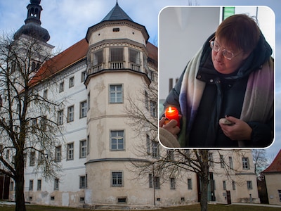 jostiband-lid-jose-de-vos-steekt-een-kaarsje-aan-ter-herinnering-aan-de-slachtoffers-van-slot-hartheim