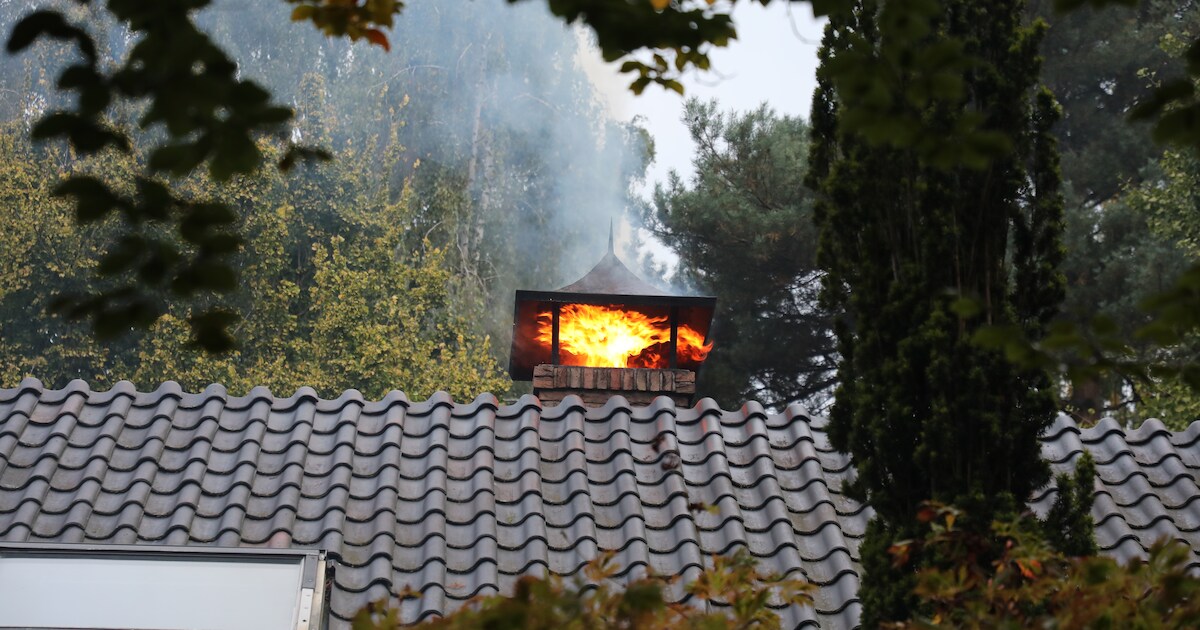 Schoorsteenbrand aan Mozartlaan in Voorthuizen, vlammen slaan uit pijp