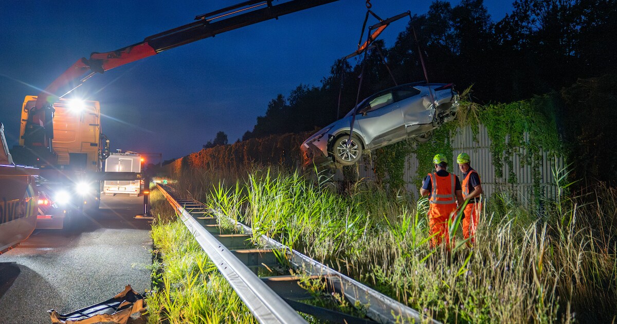 Auto belandt tussen vangrail en geluidswal langs A1 bij Bathmen: bestuurder was vermoedelijk in slaa
