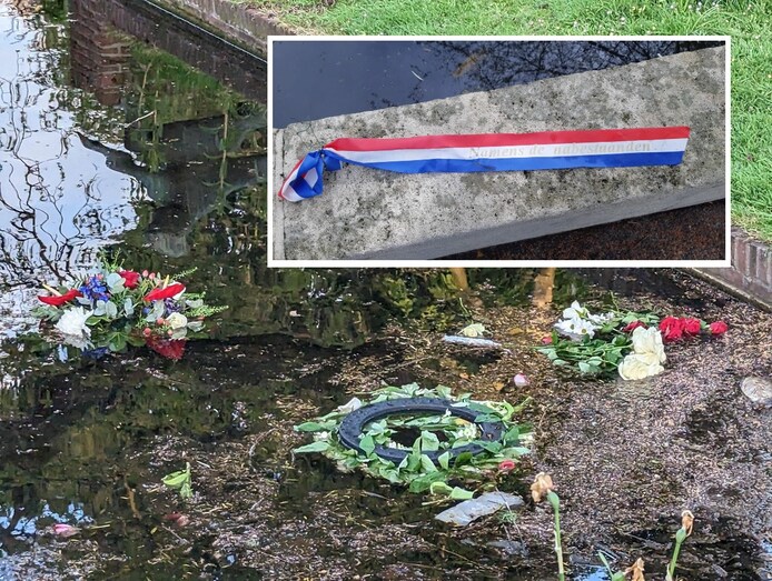 De bloemenkransen in het water, en het lint op de kant.