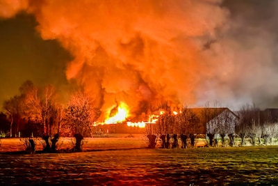 Vlammenzee en rookwolken bij grote brand in schuren in Hoevelaken