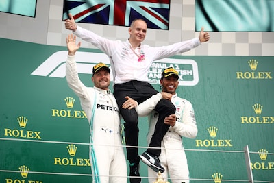 northampton-england-july-14-race-winner-lewis-hamilton-of-great-britain-and-mercedes-gp-and-second-placed-valtteri-bottas-of-finland-and-mercedes-gp-celebrate-with-mercedes-gp-chief-designer-john-owen-on-the-podium-during-the-f1-grand-prix-of-great-britain-at-silverstone-on-july-14-2019-in-northampton-england-photo-by-bryn-lennon-getty-images