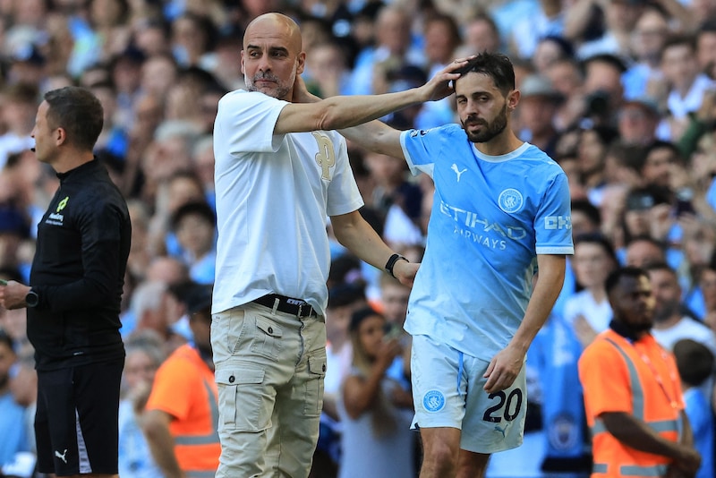 Pep Guardiola and Bernardo Silva.