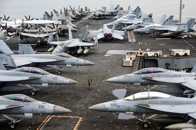 files-a-us-navy-officer-walks-past-fighter-jets-sitting-on-the-flight-deck-of-the-nimitz-class-aircraft-carrier-uss-abraham-lincoln-during-a-media-tour-in-port-klang-on-the-outskirts-of-kuala-lumpur-on-november-26-2024-a-us-naval-strike-group-led-by-the-uss-abraham-lincoln-aircraft-carrier-has-deployed-to-middle-eastern-waters-the-united-states-said-on-january-26-2026-as-tehran-warned-it-was-ready-to-hit-back-at-any-american-attack-launched-in-response-to-a-crackdown-on-anti-government-protests-photo-by-fazry-ismail-pool-afp